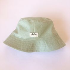 The perfect linen bucket hat! Made from a mint green linen blend fabric. This hat is very comfortable to wear. A great sun hat for women or men. I made this hat with a day of adventure in mind, somewhere sunny and wild! For baby or kid version of this hat, see link below. This hat is made from a mint green linen and cotton blend fabric. Inside liner is white cotton. Interfacing inside brim for extra shape. Brim measures approx. 2.5" wide. Crown measures approx. 3.5" deep. **Hat on models in diff Summer Cotton Hat For Everyday, Cotton Summer Hat For Everyday Wear, Everyday Summer Cotton Hat, Everyday Cotton Bucket Hat, Summer Cotton Sun Hat For Everyday, Green Travel Hat For Spring, Summer Bucket Hat For Everyday, Everyday Lightweight Sun Hat, Green Spring Travel Hat