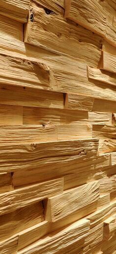 wood is stacked on top of each other in a wall that has been made out of boards