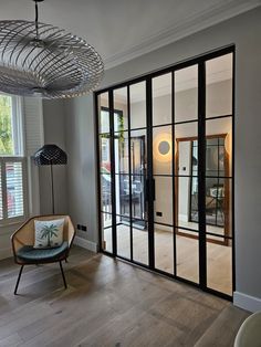 an empty living room with sliding glass doors on the wall and wood flooring in front of it