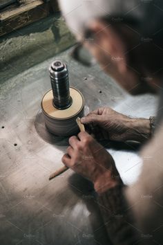 an older man working on a spinning wheel