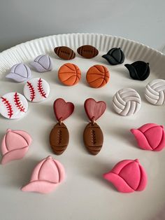 a paper plate topped with lots of different shaped cookies on top of a white table