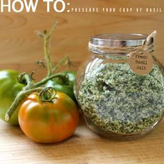 there is a jar with herbs in it next to two green and red peppers on the table