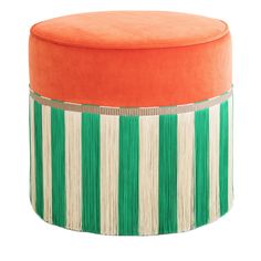 an orange and white striped ottoman with fringe trim on it's sides, sitting in front of a white background