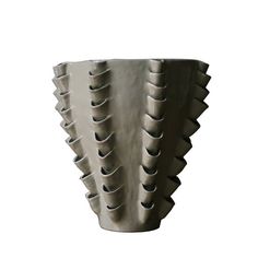 a white vase with many spikes on it