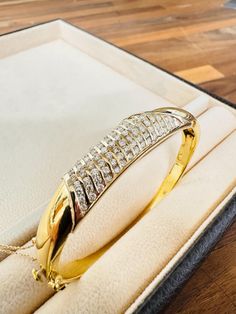 This luxurious 18K yellow gold bangle, weighing 33.5 grams, features a sophisticated design adorned with 83 channel-set diamonds totaling 1.66 carats. The bangle's elegance and craftsmanship make it a standout piece, perfect for special occasions or as a timeless addition to any fine jewelry collection. Yellow Gold Bangle, Sherman Oaks, Gold Bangle, Channel Set, Fine Jewelry Collection, Sophisticated Design, Gold Bangles, Bangle Bracelets, Jewelry Collection