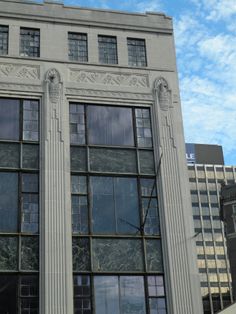 a tall building with many windows and a clock on the front