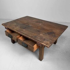 an old wooden table with two drawers