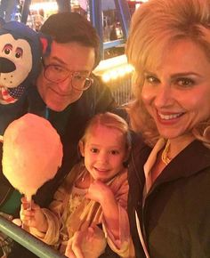 a man, woman and child posing for a photo with an ice cream sundae