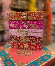 a stack of different colored boxes sitting on top of a table