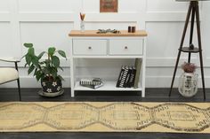 a living room with a rug, table and chair