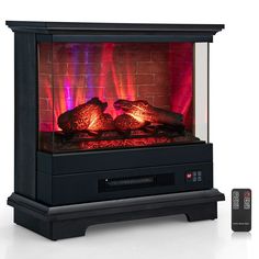 an electric fireplace with red flames and remotes next to it on a white surface