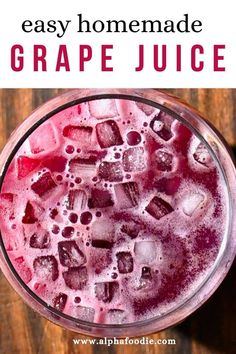 an easy homemade grape juice recipe in a glass with ice cubes on the rim