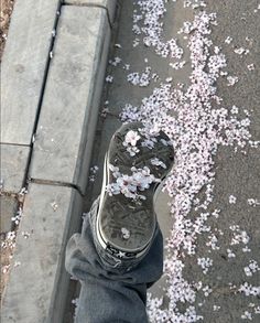 someone standing on the sidewalk with their feet covered in confetti