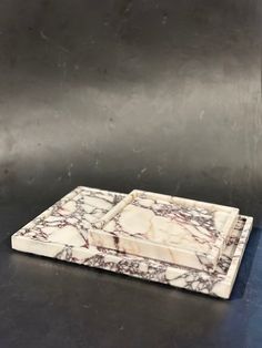 a marble tray on a metal surface