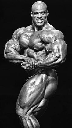 a bodybuilding man posing for the camera with his hands on his hips and arms crossed