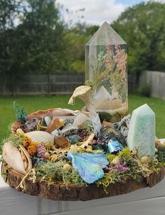 a table topped with lots of different types of rocks and glass bottles on top of it