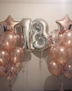 balloons and streamers are arranged in the shape of numbers