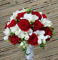 a bouquet of red roses and white orchids