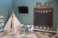 a child's playroom with a teepee tent and toys