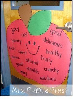 an apple shaped door with words written on it