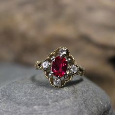 1950's Beautiful 1950's Vintage Deco Ruby Topaz Ring 10K Solid Gold Ruby White Topaz Ring 2.9 Grams Size 6 1tcw Ruby Engagement Ring Vintage Gold Ruby Rings 10K This is a stunning ruby ring, 1tcw ruby & white topaz ring in solid 10K yellow gold 1950's The face of the ring measures 1/2 x 5/8" The center ruby is 1tcw and measures 3/16 x 5/16" There are 4 small white topaz that surround the face of the ring, and they are 1/8tcw each one  Size 6 weight 2.19grams Stamped 10K (solid yellow gold) Makers marks Great vintage condition, beautiful ruby topaz ring Great looking ring. Please look at all photos as they are part of the description. Please note the ring is shipped out unpolished. Thanks for stopping by Vintage 14k Gold Ruby Birthstone Ring, Victorian 14k Gold Cluster Ring With Gemstone, Victorian Yellow Gold Rings With Accent Stones, Vintage Ruby Ring With Rose Cut Diamonds, Vintage Yellow Gold Ruby Birthstone Ring, Vintage Yellow Gold Ruby Ring Birthstone, Heirloom Cluster Ring With Accent Stones In 14k Gold, Vintage Yellow Gold Gemstone Ring, Vintage 14k Gold Rings With Accent Stones