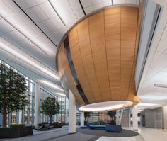 the inside of an office building with lots of windows and large circular wood paneled ceiling