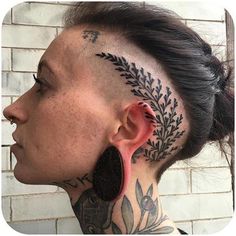 a woman with tattoos on her neck and ear