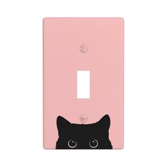 a light switch cover with a black cat's face on the front and bottom