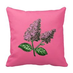 a pink pillow with purple flowers on it