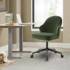 a green office chair sitting in front of a desk with a laptop computer on it