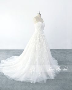 a white wedding dress on a mannequin in front of a gray background with the words love bridal