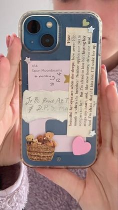 a person holding up a cell phone case with writing on it