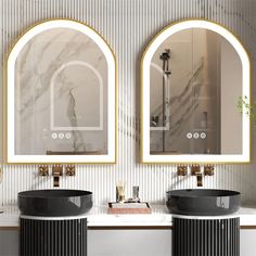 two black sinks sitting under mirrors in a bathroom