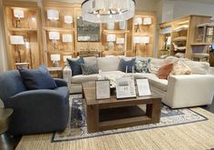 a living room filled with furniture and lots of pillows on top of a carpeted floor