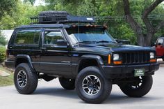 a black jeep is parked on the street