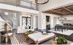 a living room filled with furniture and a spiral staircase