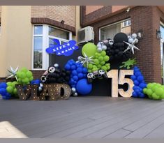 an entrance to a building decorated with balloons and decorations for the 15 year anniversary celebration