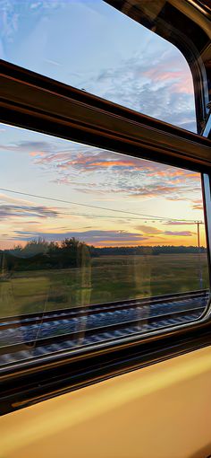 the view from inside a train window at sunset