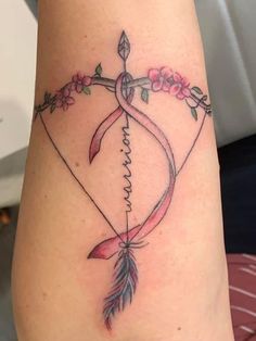 a woman's arm with a tattoo on it that says, love and arrows