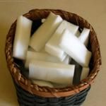 a basket filled with white candles on top of a table