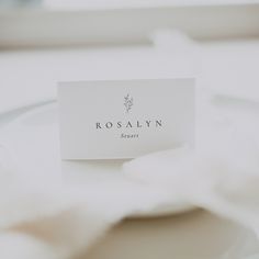 a place card sitting on top of a white plate