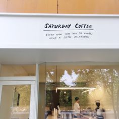 the front window of a coffee shop with people walking in and sitting at their tables