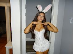 a woman wearing bunny ears poses for the camera