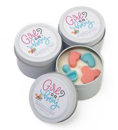 three tins filled with candy hearts sitting next to each other