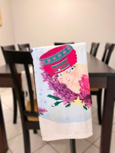 a tea towel with an image of a woman's head on it hanging from a table