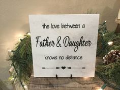 a sign that says the love between a father and daughter knows no distance