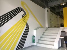 the stairs are painted with black and yellow lines on them, along with a white stair case