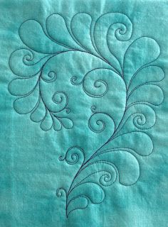 a close up of a piece of fabric with swirls and leaves on the side