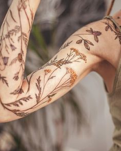 a woman with tattoos on her arm and arms