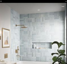 a white bath tub sitting next to a toilet under a faucet in a bathroom